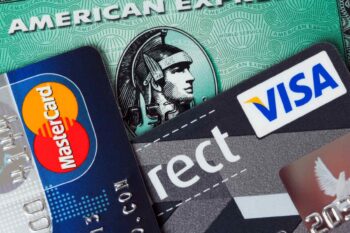 american-express-travel-insurance three credit cards in a pile including an American Express card which comes with American Express travel insurance