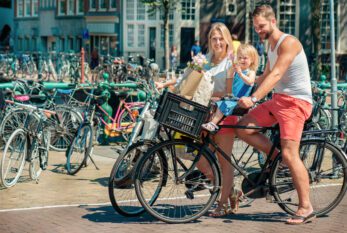 Dutch family on bikes in Amsterdam Dutch family on bikes in Amsterdam