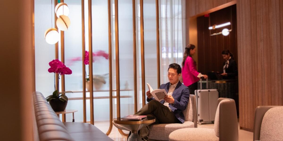 airport-lounge an Asian man reading and relaxing in a quiet airport lounge in a VIP lounge at Singapore Changi Airport