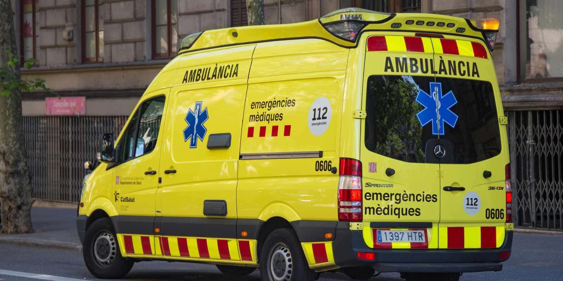 ambulance-in-spain a yellow ambulance driving along a street in central Barcelona