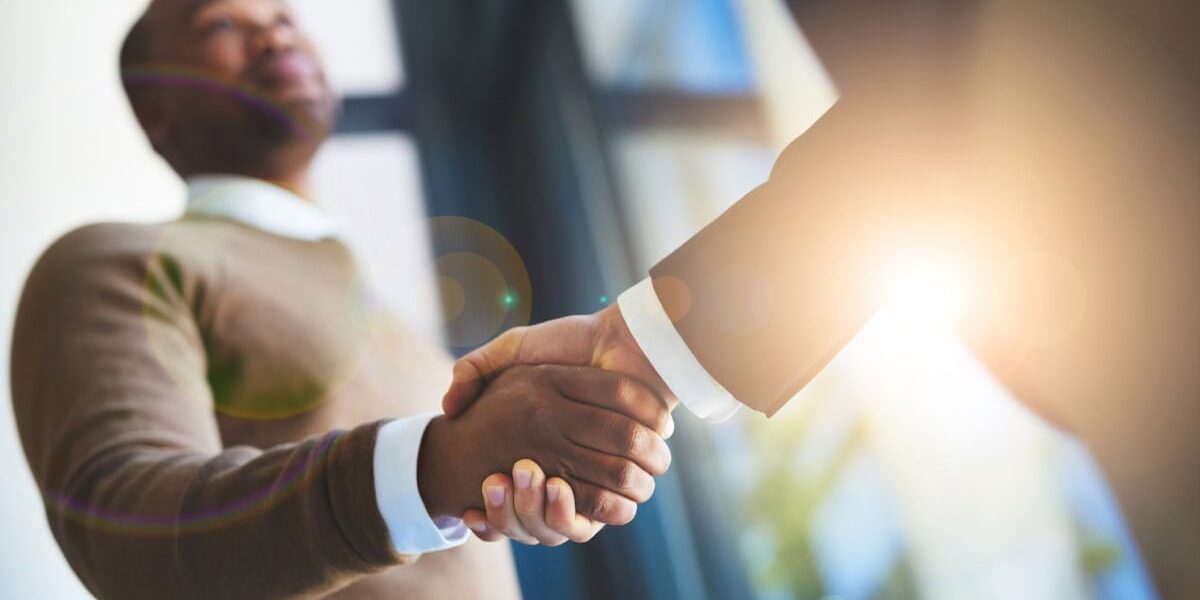 businessmen-shaking-hands two businessmen shaking hands, representing a strong professional relationship and the importance of securing insurance for employees