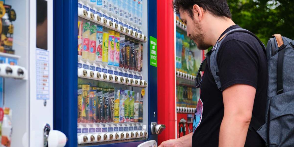drinks-vending-machine a tourist buying a beverage at a Japanese vending machine