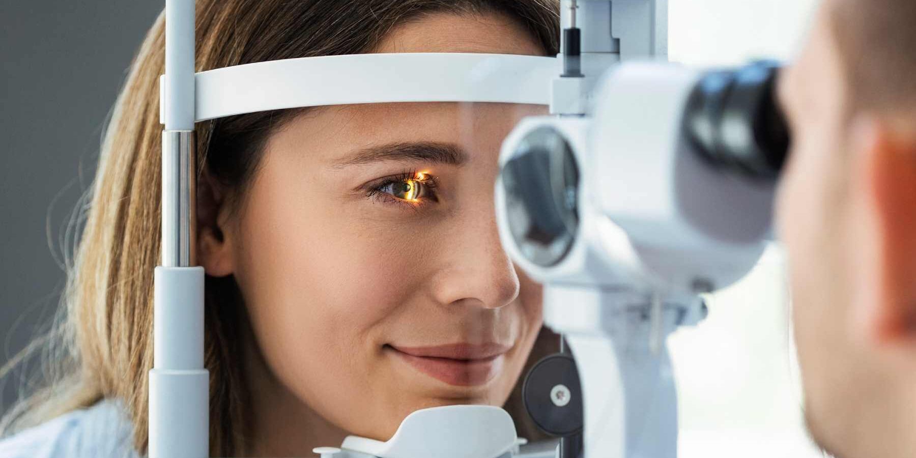 eye-test a young woman having an eye exam at an ophthalmology clinic