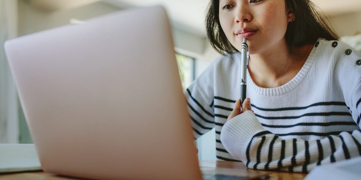 female-student-on-laptop a female student researching the best health insurance for students studying abroad