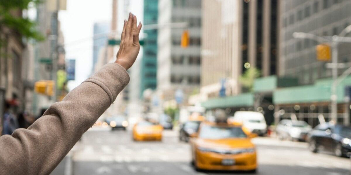 hailing-taxi-cab a young woman hailing a licensed taxi in New York in an attempt to reduce the risk of falling victim to terrorism