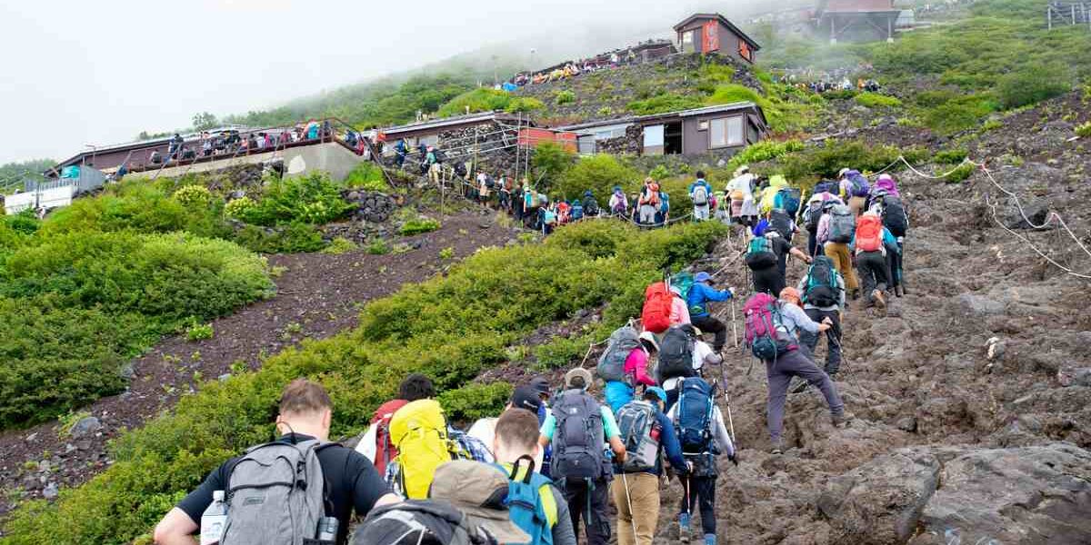 hiking-mount-fuji hikers climbing Mount Fuji in Japan, highlighting the important of purchasing travel insurance for Japan
