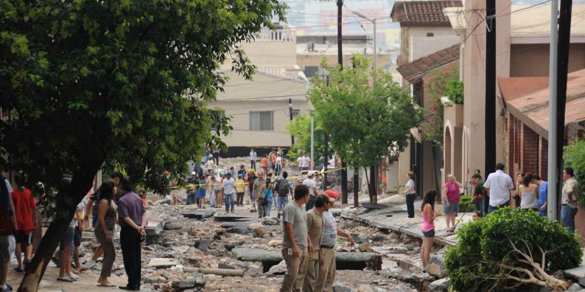hurricane-mexico damage to a street and cars after Hurricane Alex in Monterrey Mexico, where tourists are advised to buy travel insurance for Mexico