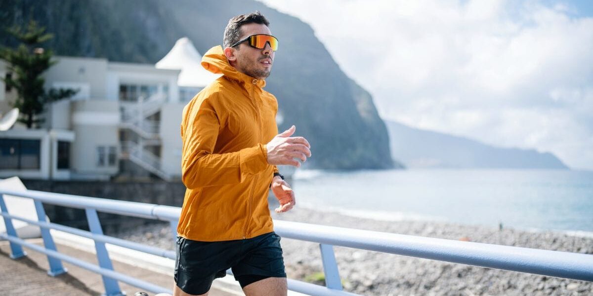 man-jogging a man jogging in the sun, wearing UV protection sunglasses, one of the best skin care tips for expats