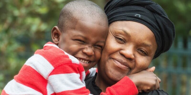 mother-and-son a happy Caribbean woman smiling and hugging her son