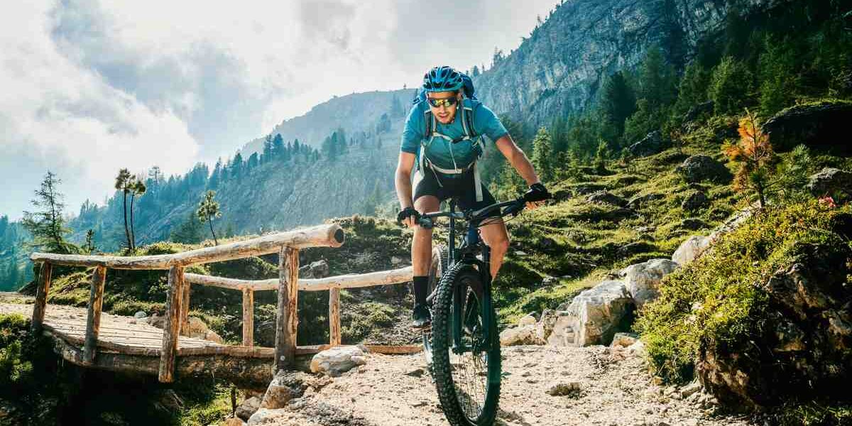 mountain-biking A mountain biker riding through the rugged terrain of the Dolomites in Italy during his adventure travel experience