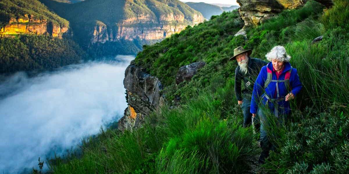 seniors-hiking a senior couple hiking in the Australian mountains, highlighting the important of buying travel insurance for Australia