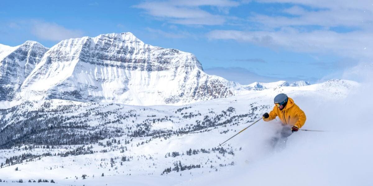 skiing-in-mountains a person skiing in Alberta’s Rocky Mountain in Canada, after buying travel insurance for Canada
