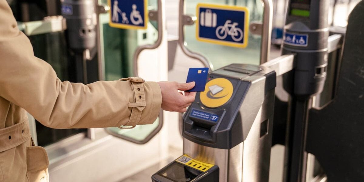 train-ticket-barrier a woman using card for getting through ticket barrier in London, where tourists are advised to buy UK travel insurance