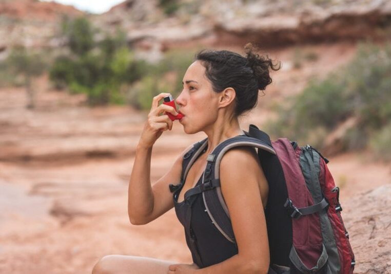 Woman With Chronic Asthma Hiking in Desert woman experiencing acute onset of pre-existing asthma condition while hiking